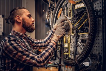 a dude fixing a bike